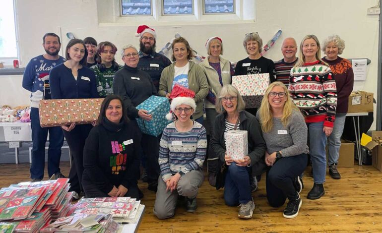 Over 70 volunteers help pack presents for young people in hospital